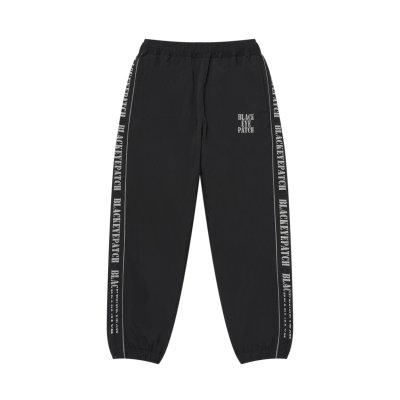 画像1: BLACK EYE PATCH (REFLECTIVE STENCIL LOGO TRACK PANTS) BLACK