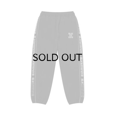 画像1: BLACK EYE PATCH (REFLECTIVE STENCIL LOGO TRACK PANTS) BLACK